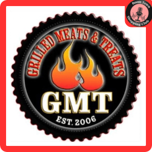 A circular logo with a fiery flame design in the center and the acronym "GMT" in bold white letters below it. Surrounding the flame, the text reads "Grilled Meats & Treats $10 Gift Card" and "Est. 2006." The logo has a red border with a label "Boom Town Shopping Club" at the top right.